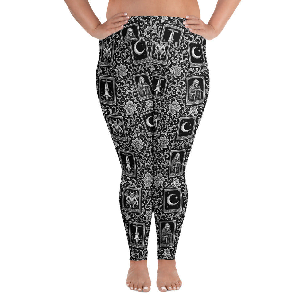 Death’s Fortune plus size tarot horror leggings featuring The Moon, The Devil, Death and The Hanged Man in an ornate black-and-white mystical pattern.