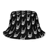 Raise the Devil reversible bucket hat featuring skeleton hand and devil-horns horror artwork on one side and a black My Evil Things branded reverse side.